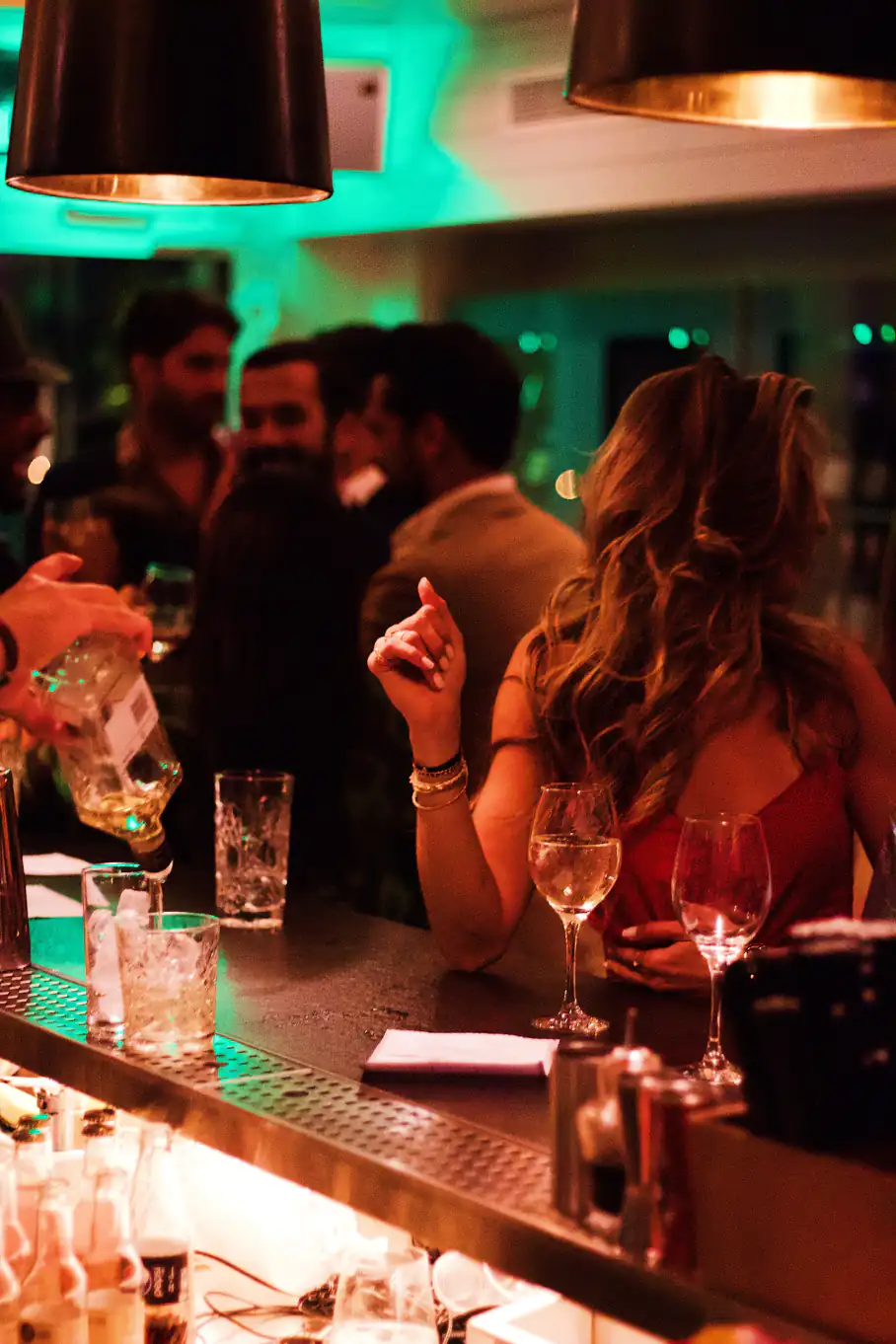 Photo of a lady being served drinks at a bar